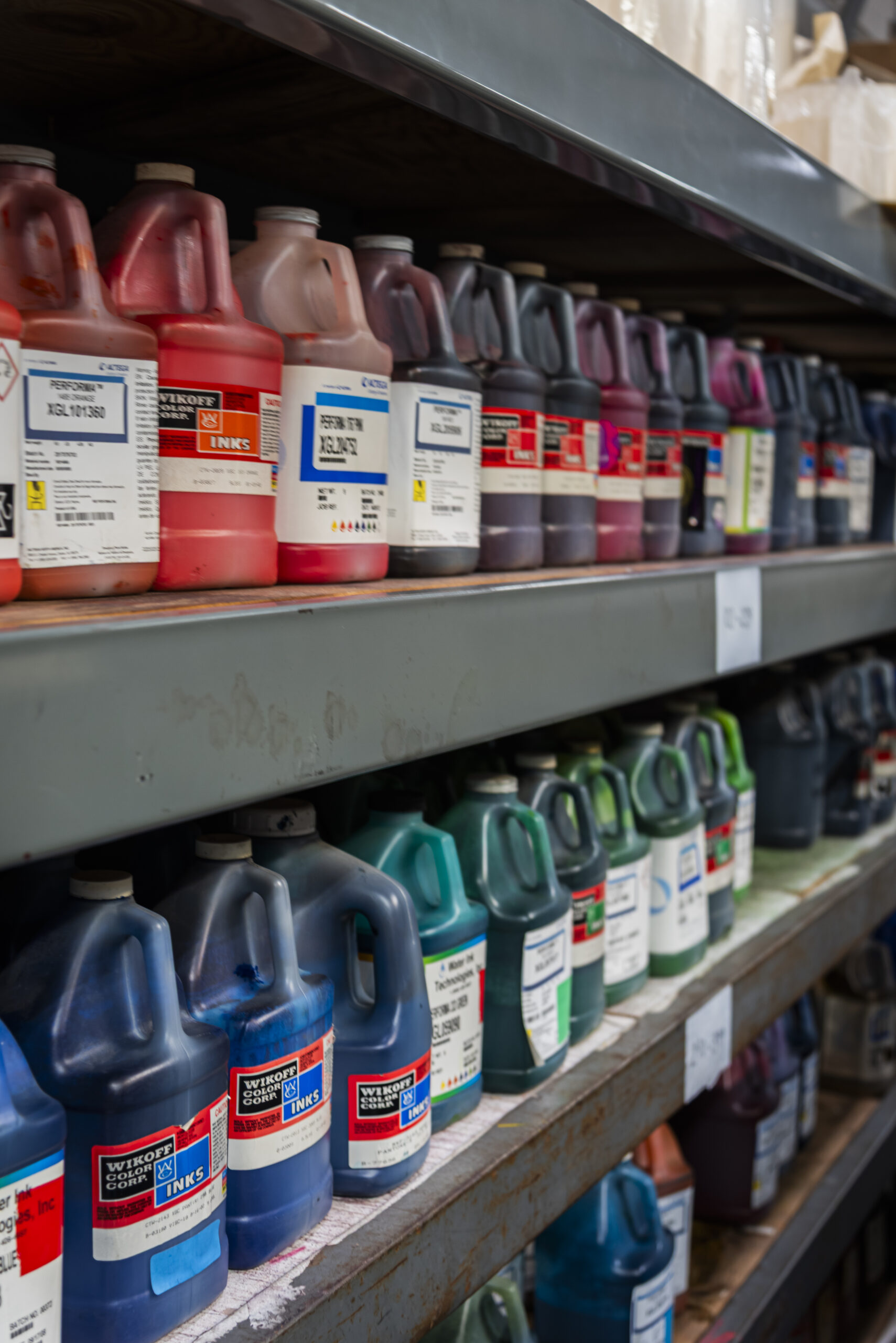 varying colors of ink sittin on a shelf